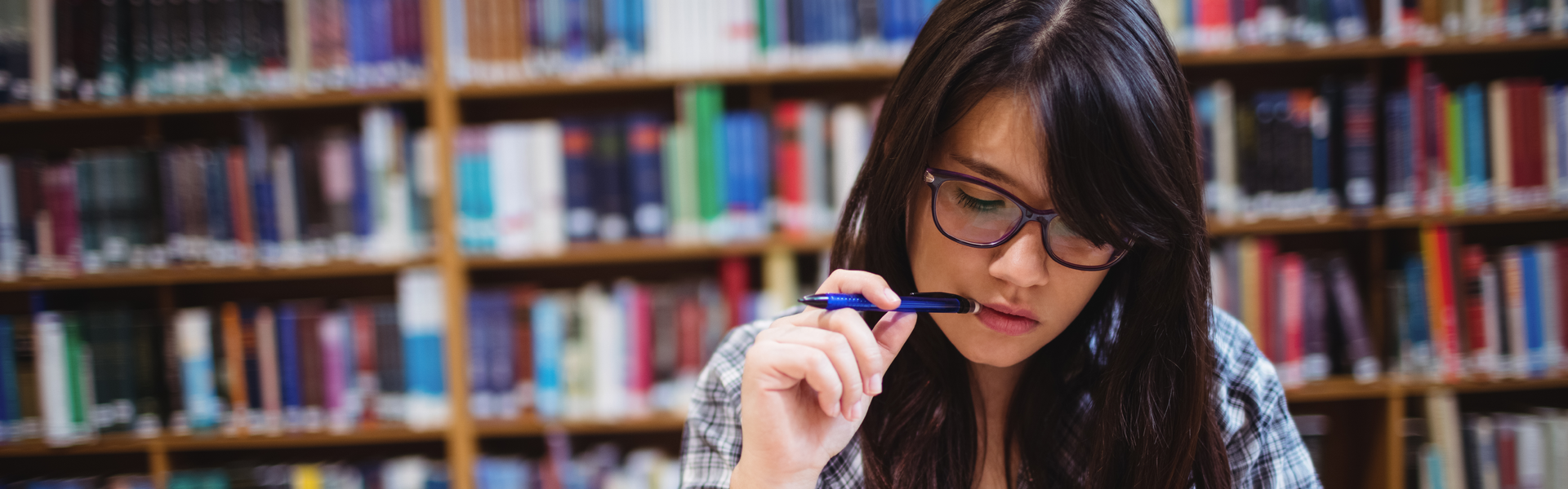 A woman studying in a library.