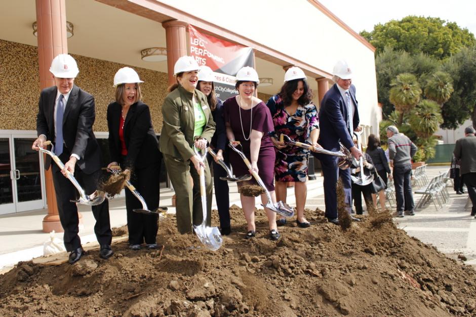 LBCC leadership members holding shovels and standing on a mound of dirt.