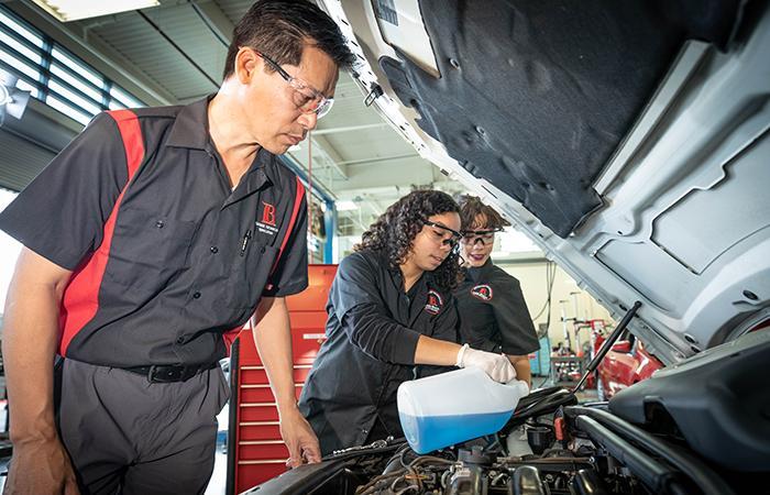 lbcc-trade-instructor & 2 female student fixing a car