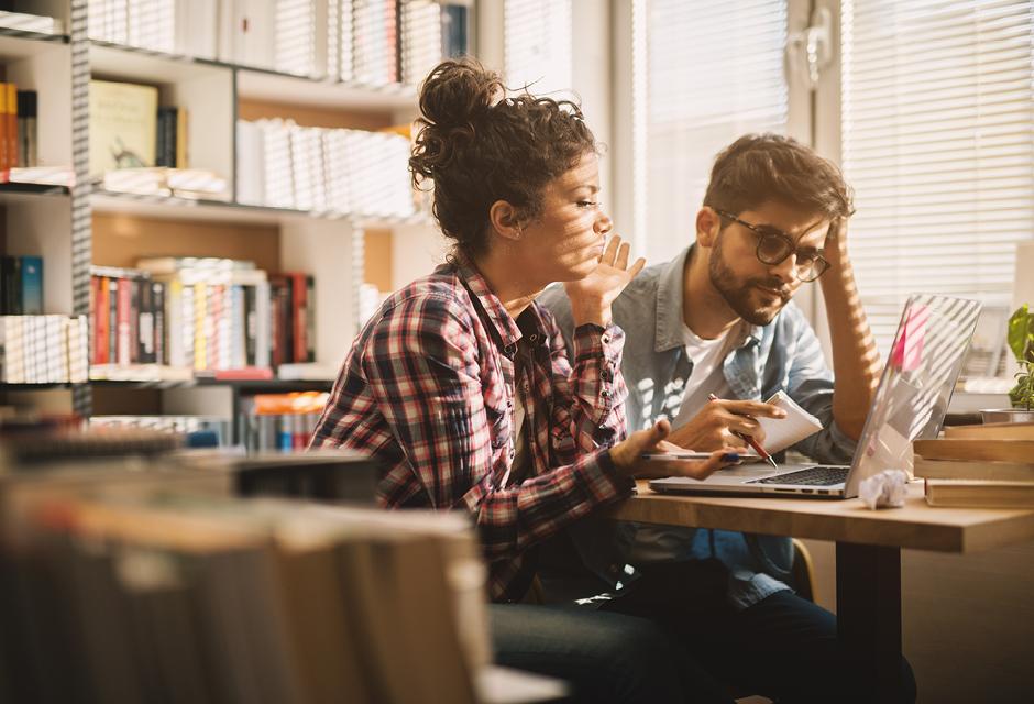 Students preparing for documents in a library