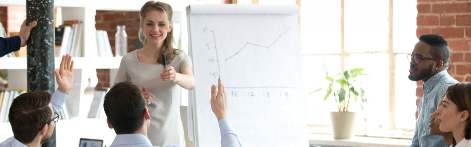 female mentor invite employee present idea on flipchart