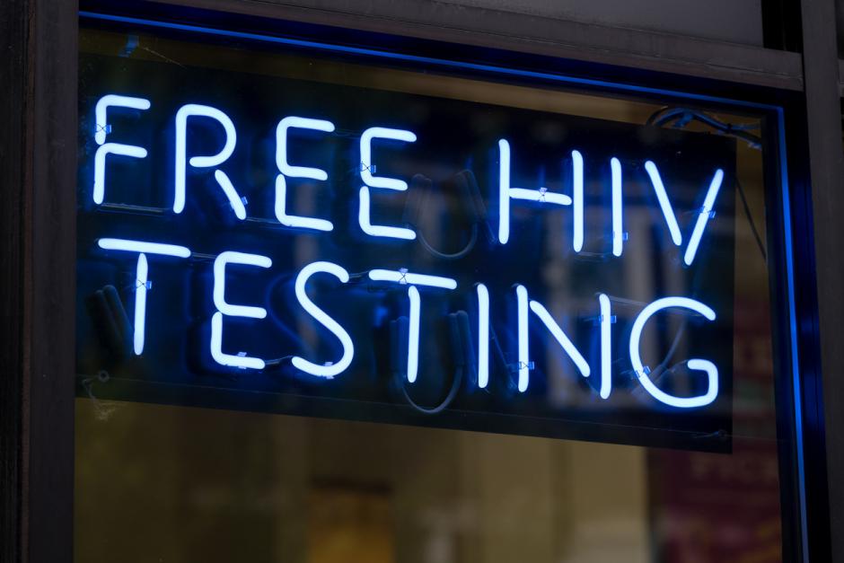 A blue neon free HIV testing sign.