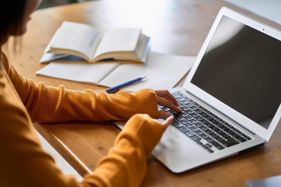 Asian woman's hand studying for qualifications