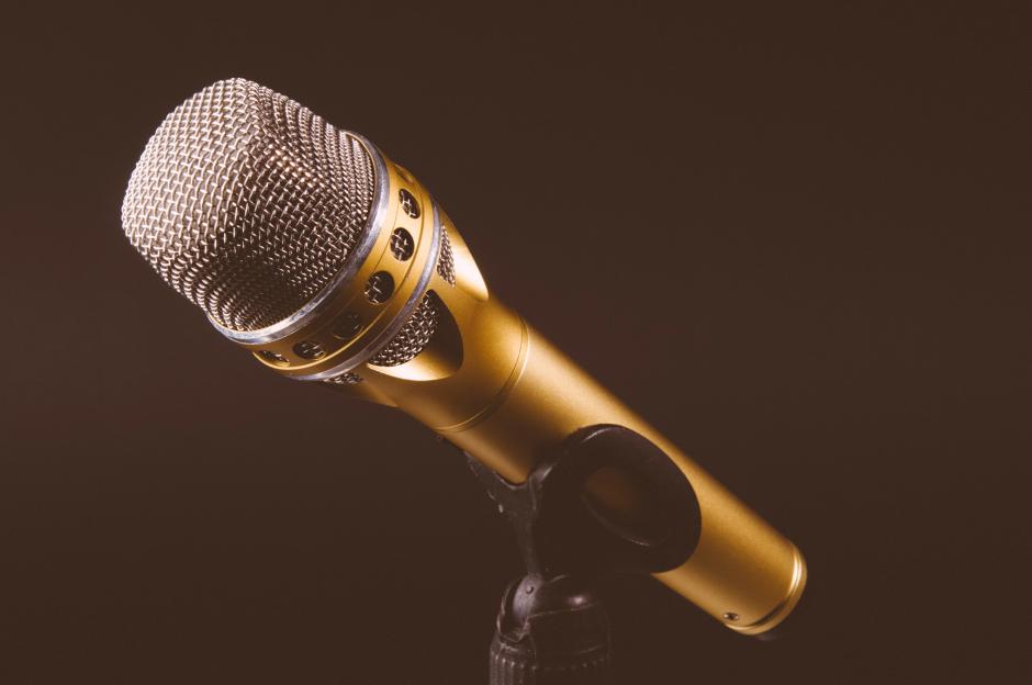 A gold-colored microphone on a stand.