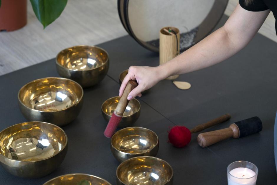 A girl plays Tibetan singing bowls.