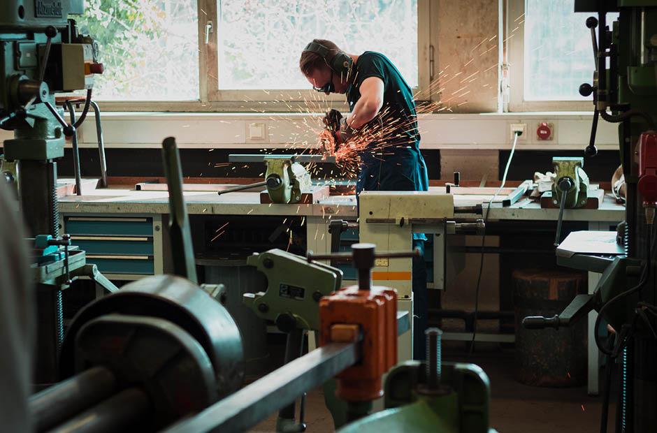 A student practicing welding techniques with lab equipment