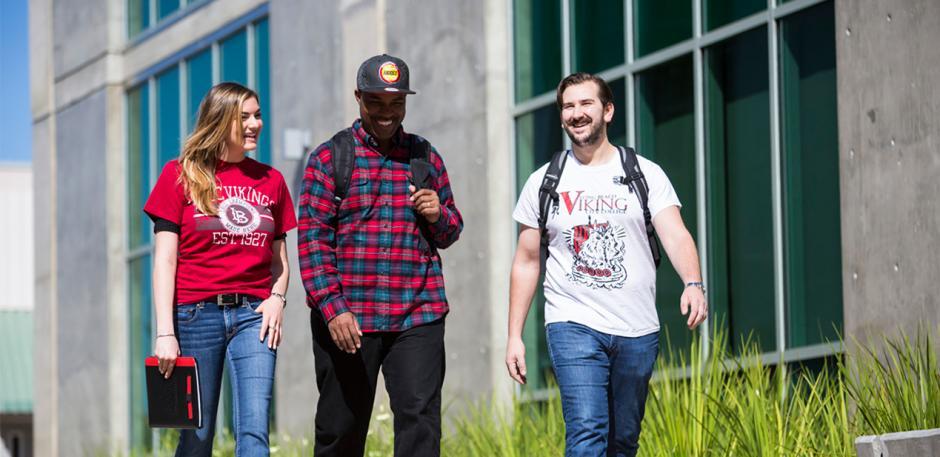 3 students smiling, walking - PCC campus