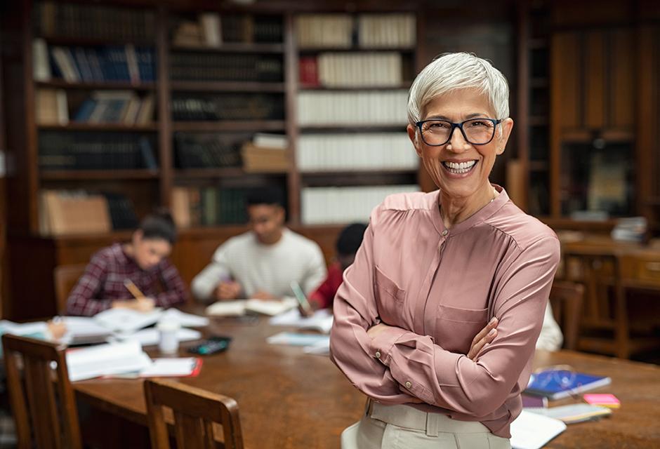 Smiling university professor in library