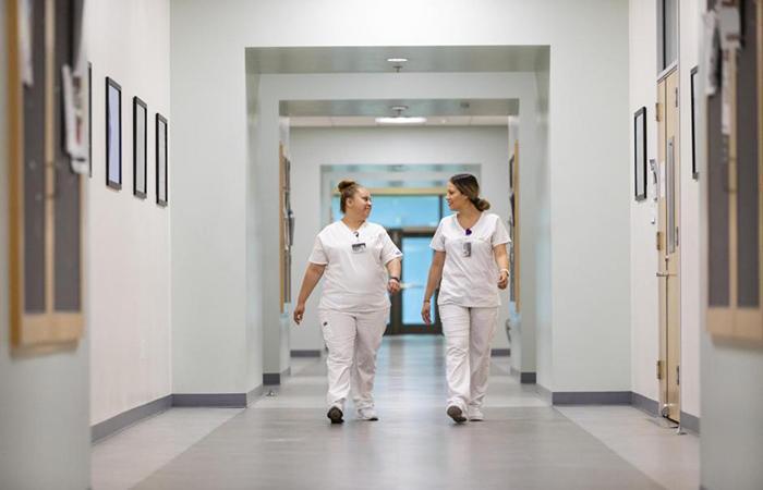 PCC- 2 nursing femal Student walking in the hallway