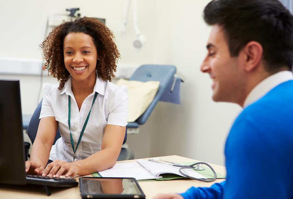 Female Consultant Meeting With Male Patient