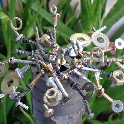 Nuts and bolts stuck to a magnet.