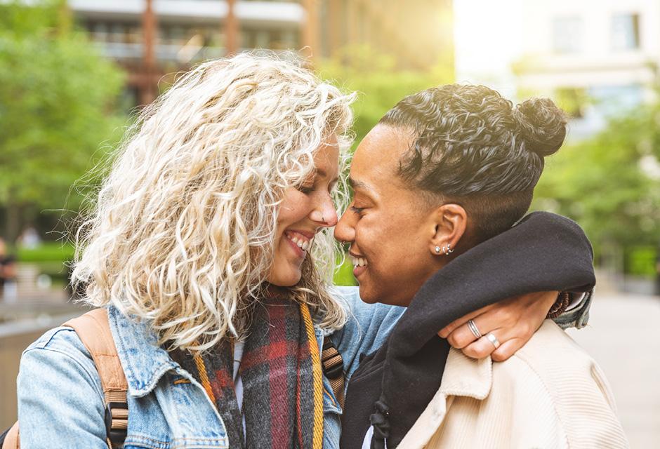 Happy multiracial girlfriends in love embracing 