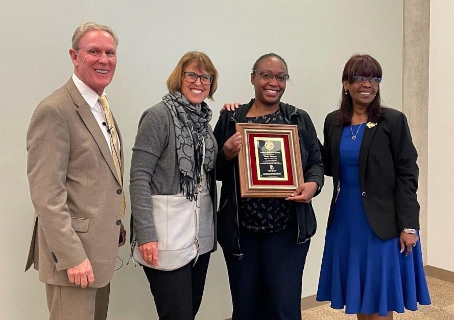 a group photo of four: Starla Thomas who is the  award winner 