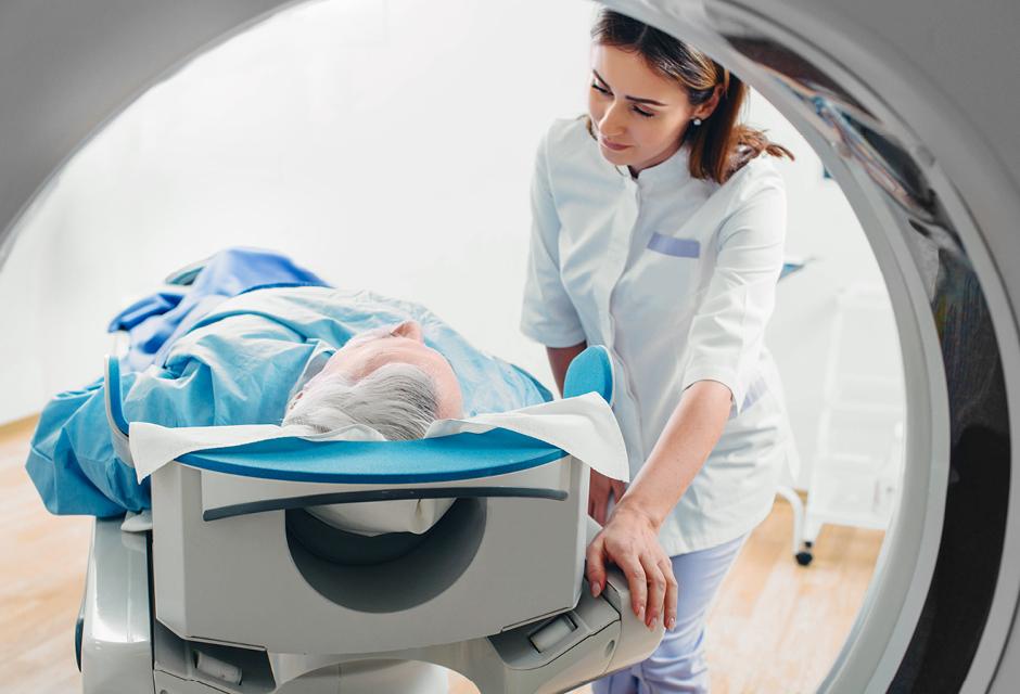 Friendly doctor talking to patient . CT Scan in hospital 