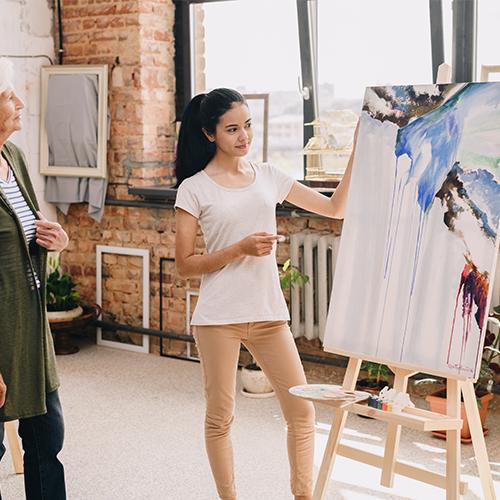 Artist explaining her art in a studio