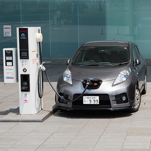 Electrical Vehicles parked at charging station.