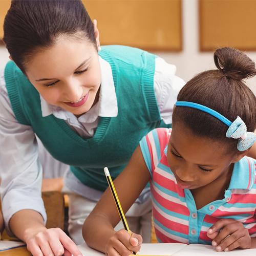 Teacher helping with student in the classroom