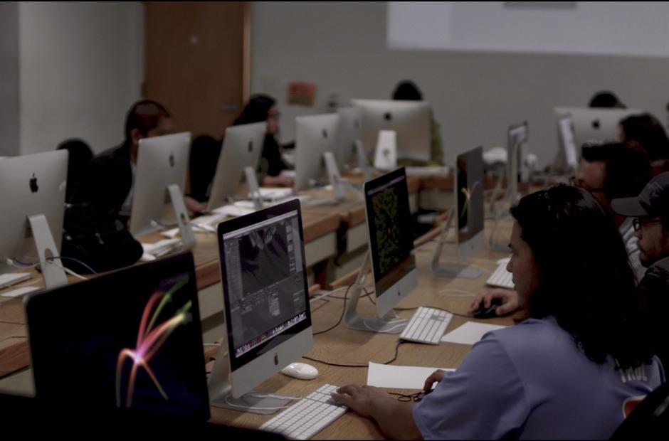 Students working on graphic design projects ina computer lab.