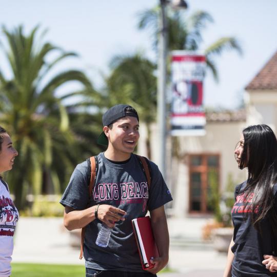 3 lbcc students in LAC campus chatting with each other